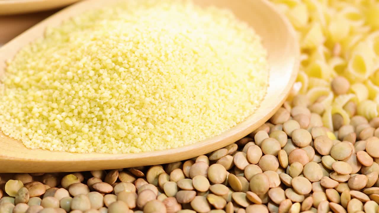 A detailed view of quinoa, lentils, couscous, and pasta, highlighting textures and colors in bright lighting