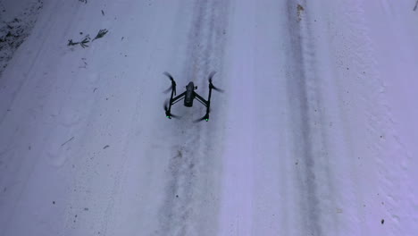 drone flying at winter snowy forest. drone with professional cinema camera flying over winter forest