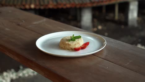 little napoleon cake with strawberries on top standing on a white plate