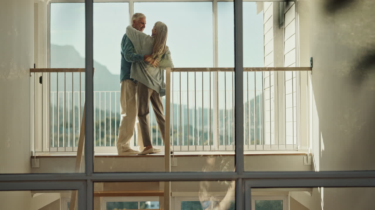 Elderly couple enjoying a romantic dance on their balcony