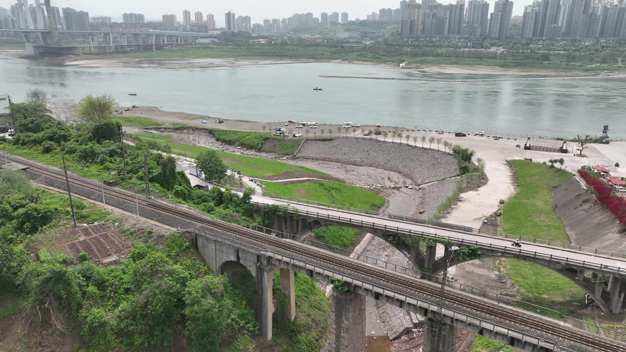 A girl is riding a small motorcycle on an ancient bridge