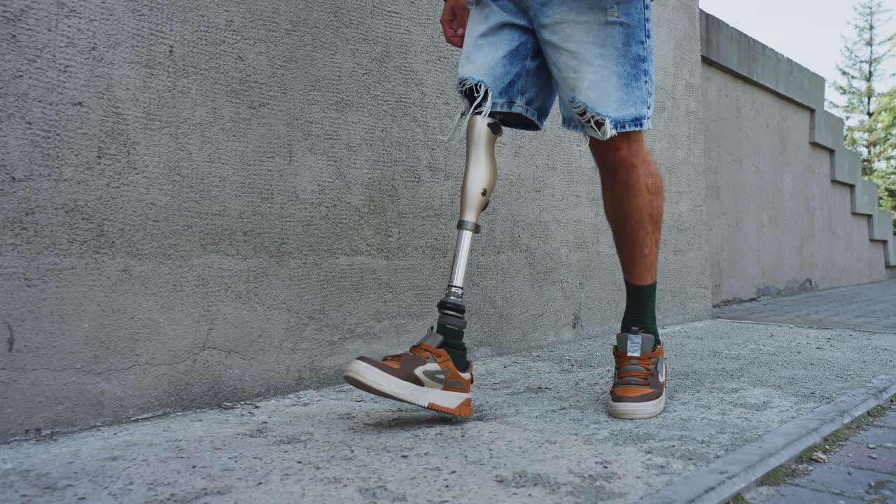 Man with prosthetic leg walking outdoors