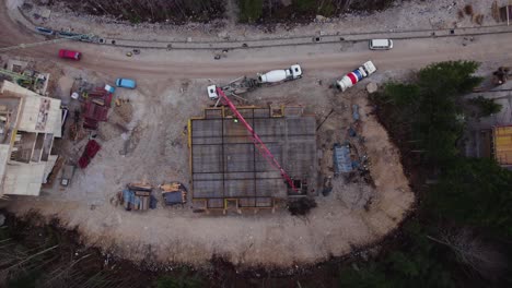 downward camera movement that show big construction site with workers in a destroyed forest