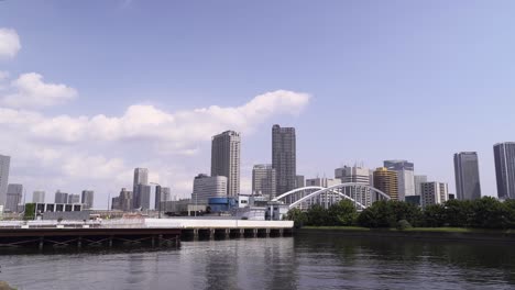 sea level view of skyscrapers of odaiba, tokyo with blue sky and clouds