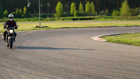 cornering casually on a roadster motorcycle wearing protective gear