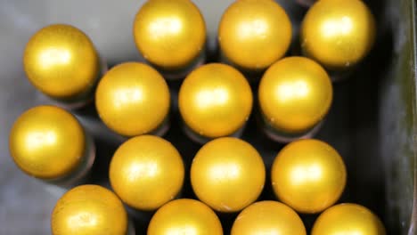 at a ukrainian workshop in donetsk, an overhead view shows grenades awaiting plastic casing conversion for drone attachment. adaptive weapon tech.