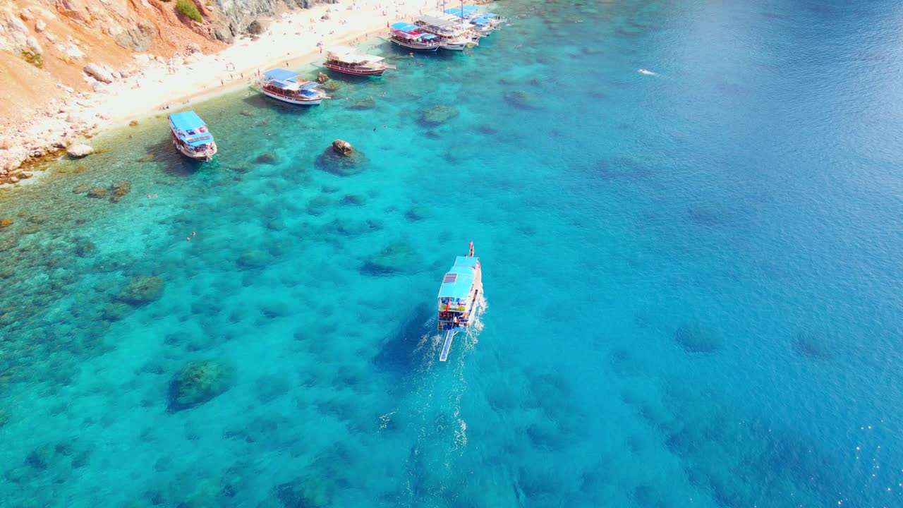Aerial 4K drone view of a boat riding to the Suluada Island in Adrasan Sea, Antalya &ndash; Turkey