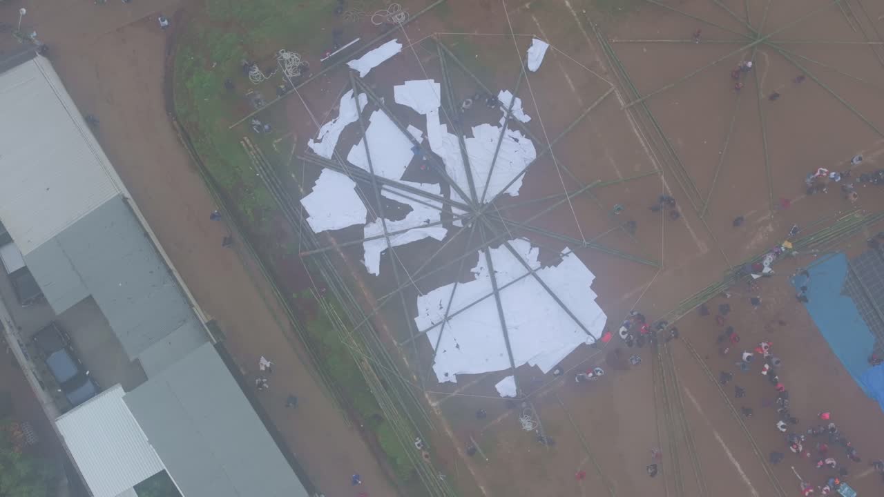Aerial view of vibrant kite festival with large crowd in Sumpango Sacatepequez Guatemala