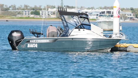 boat docking at marina with visible buoy