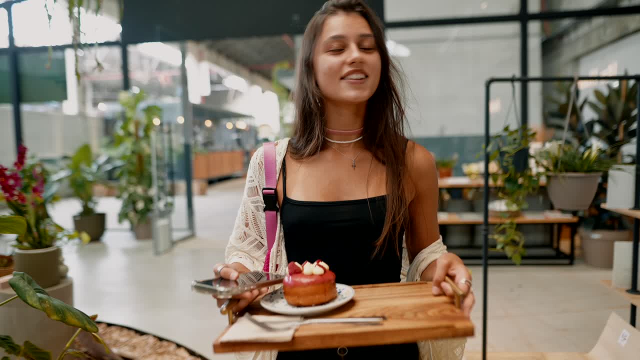 A woman in a plant shop with a cupcake