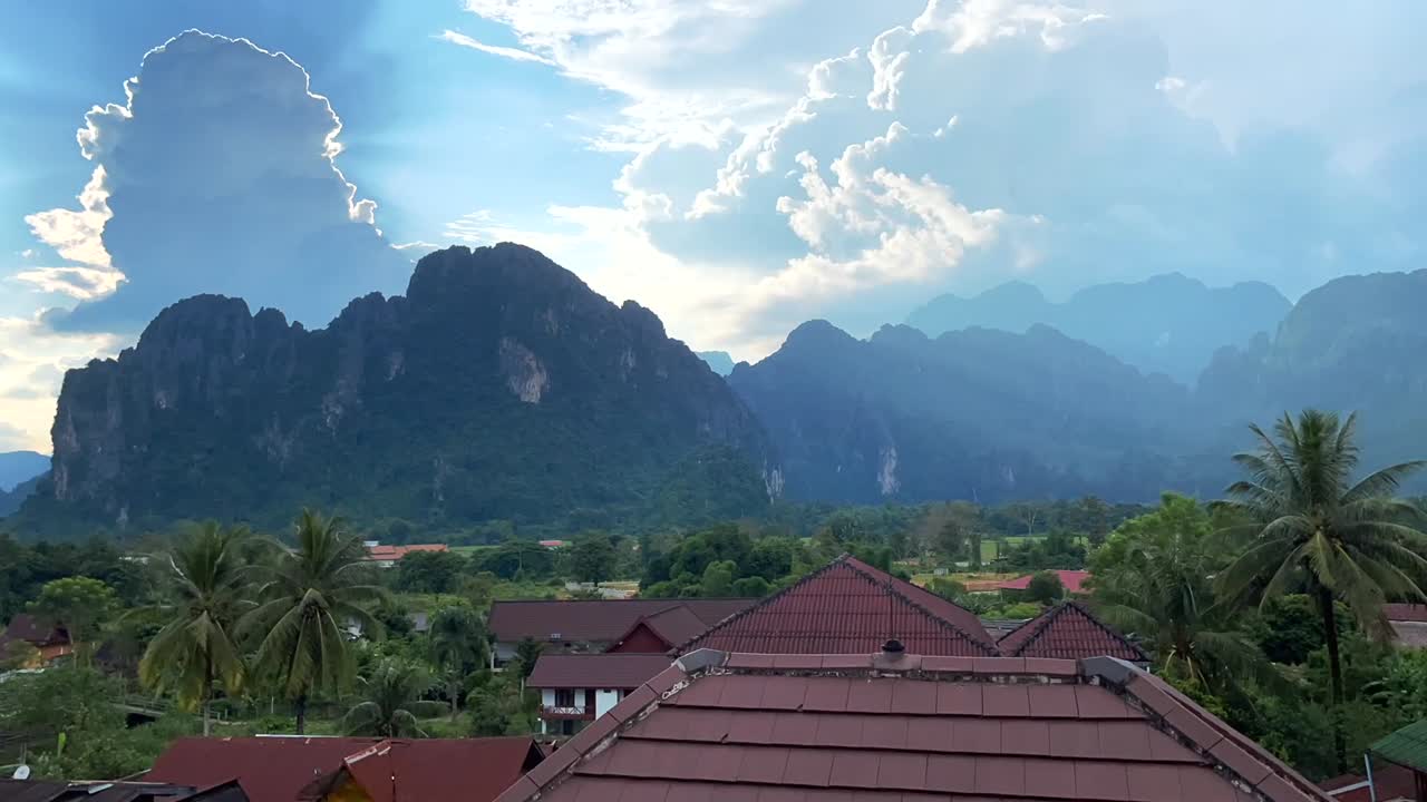 Timelapse over the city of Vang Vieng in Laos, showing clouds moving rapidly over the magnificent mountains