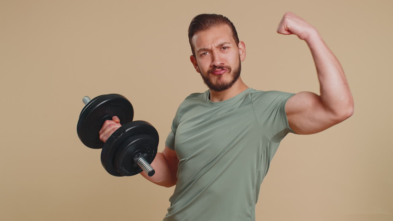 Athlete man looking approvingly at camera showing thumbs up like sign positive something good