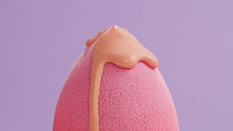 pink makeup sponge with dripping liquid