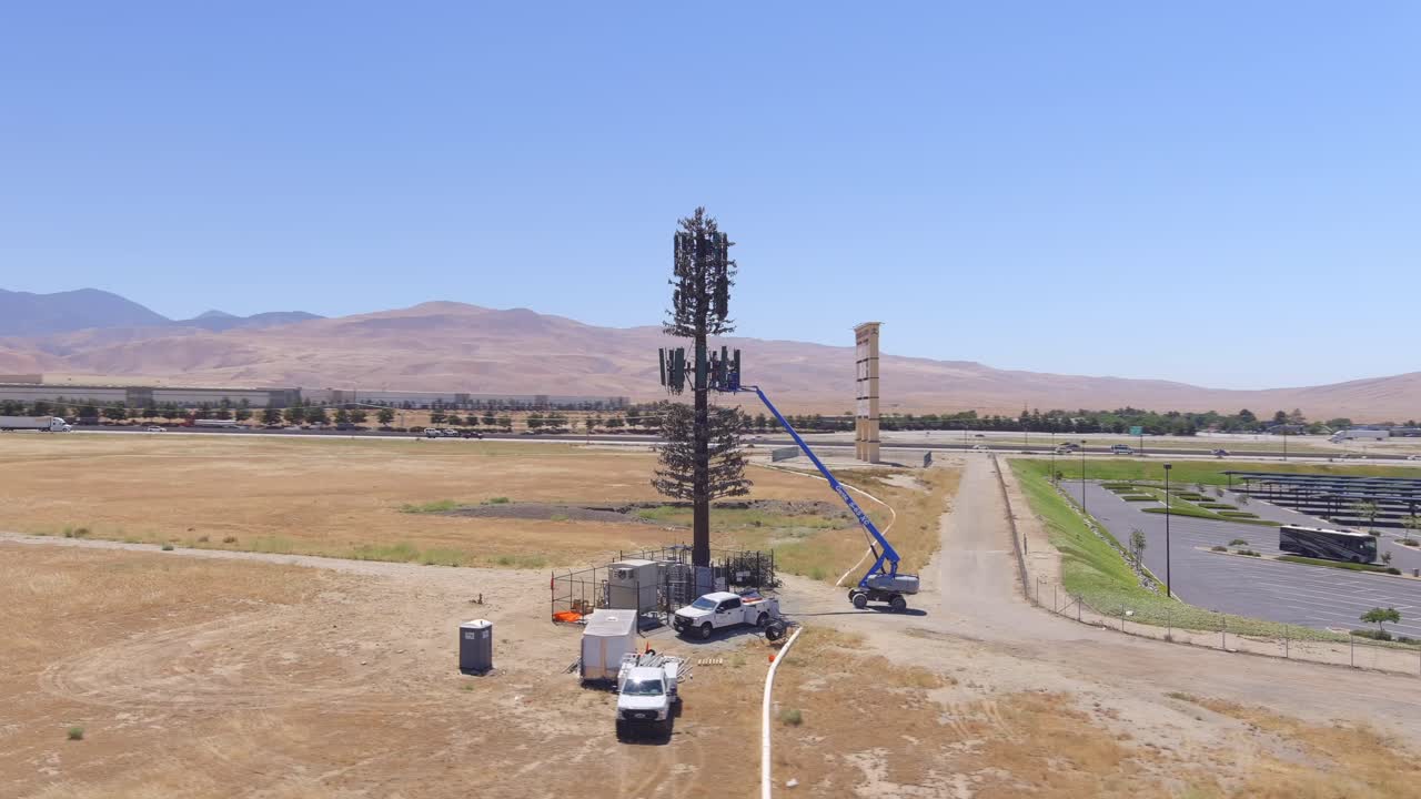 minigrúa montada en una torre de telecomunicaciones durante la reparación cerca de puntos de venta en tejon en california, estados unidos