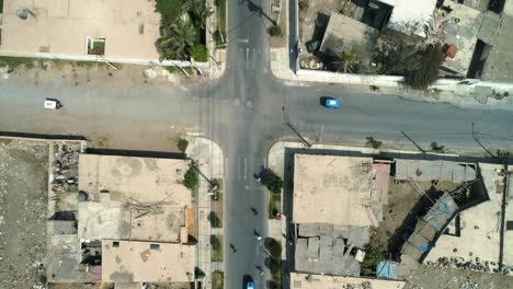 Aerial-birds-eye-shot-above-a-group-of-people-skating-on-the-streets-of-Huacho,-Peru