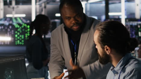 Vertical video Server farm manager overseeing engineer examining neural network algorithms