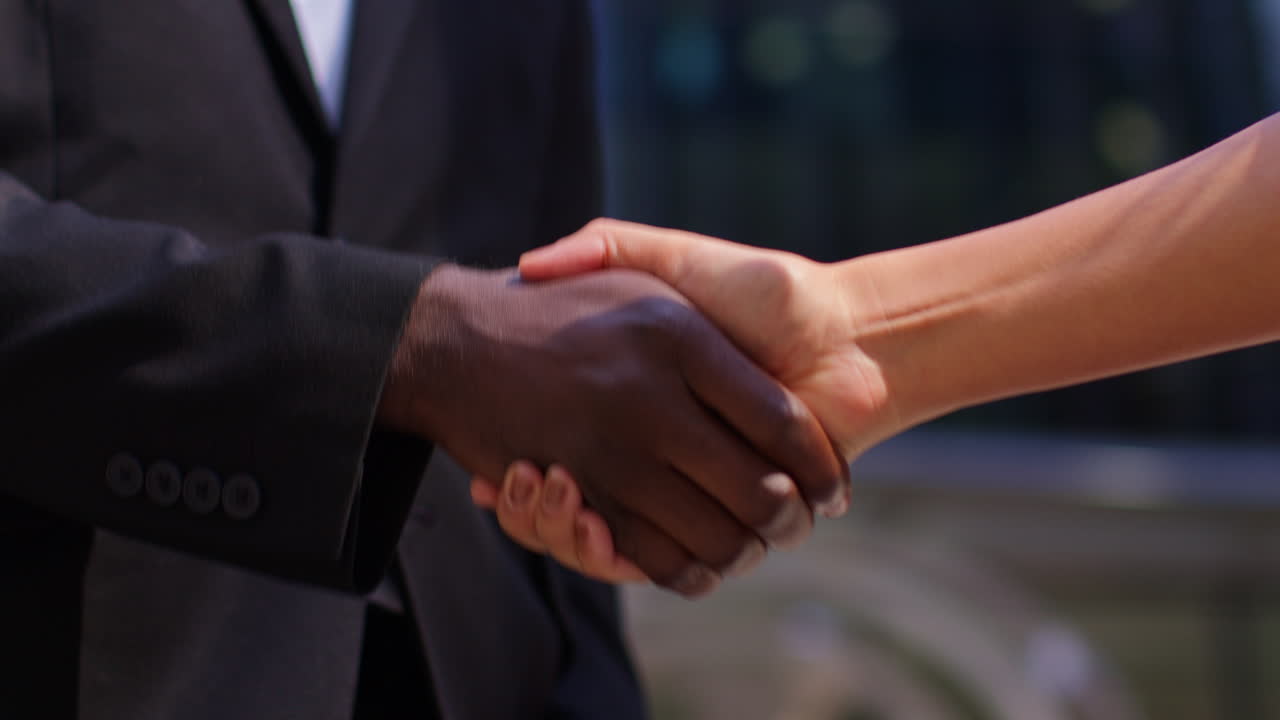 Close Up Of Businessman And Businesswoman Shaking Hands Outside Offices In The Financial District Of The City Of London UK 1