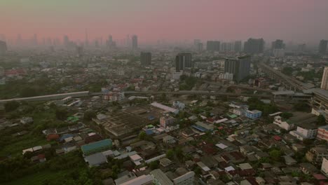 bangkok skyline at dusk, warm hues over cityscape, aerial view