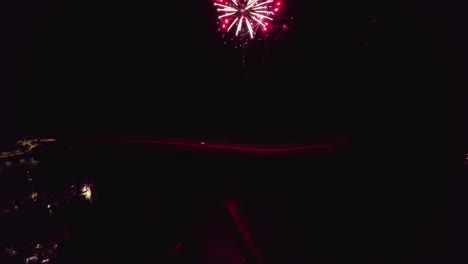 Aerial-moving-away-from-fireworks-celebration-at-night-over-Mindarie-Marina-in-Perth-Western-Australia