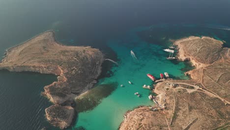 aerial drone tilt down view of malta's iconic blue lagoon, renowned for its mesmerizing clear waters