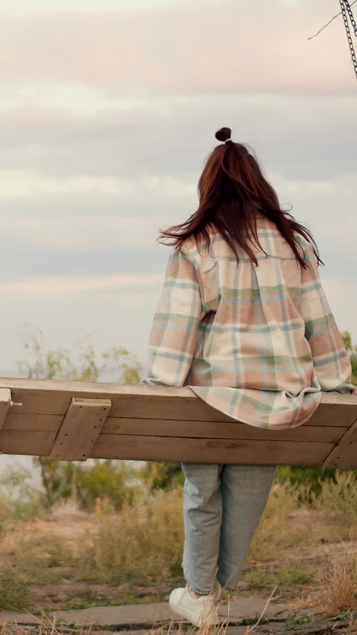 Woman on a swing enjoying the view