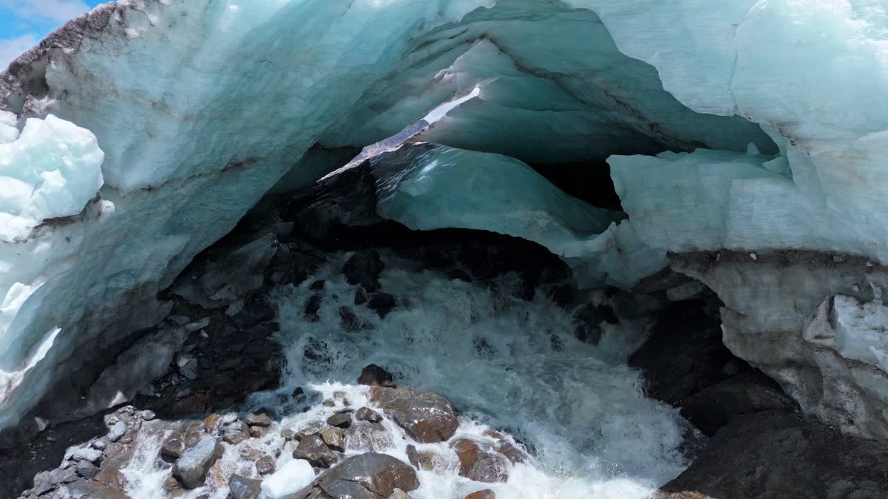 Aerial view of Morteratsch Glacier with ice and flowing water, nature scene