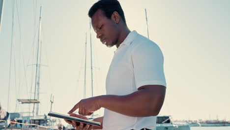 Yacht,-tablet-and-captain-with-black-man-on-pier