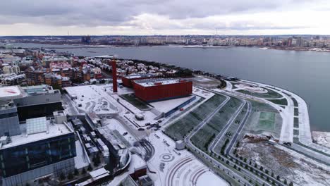 industrial complex buildings on hilly bank of tranquil river