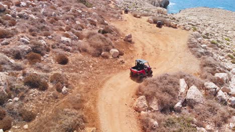 four wheeler dune buggy pulls up to the coast and reaches its destination by the sea