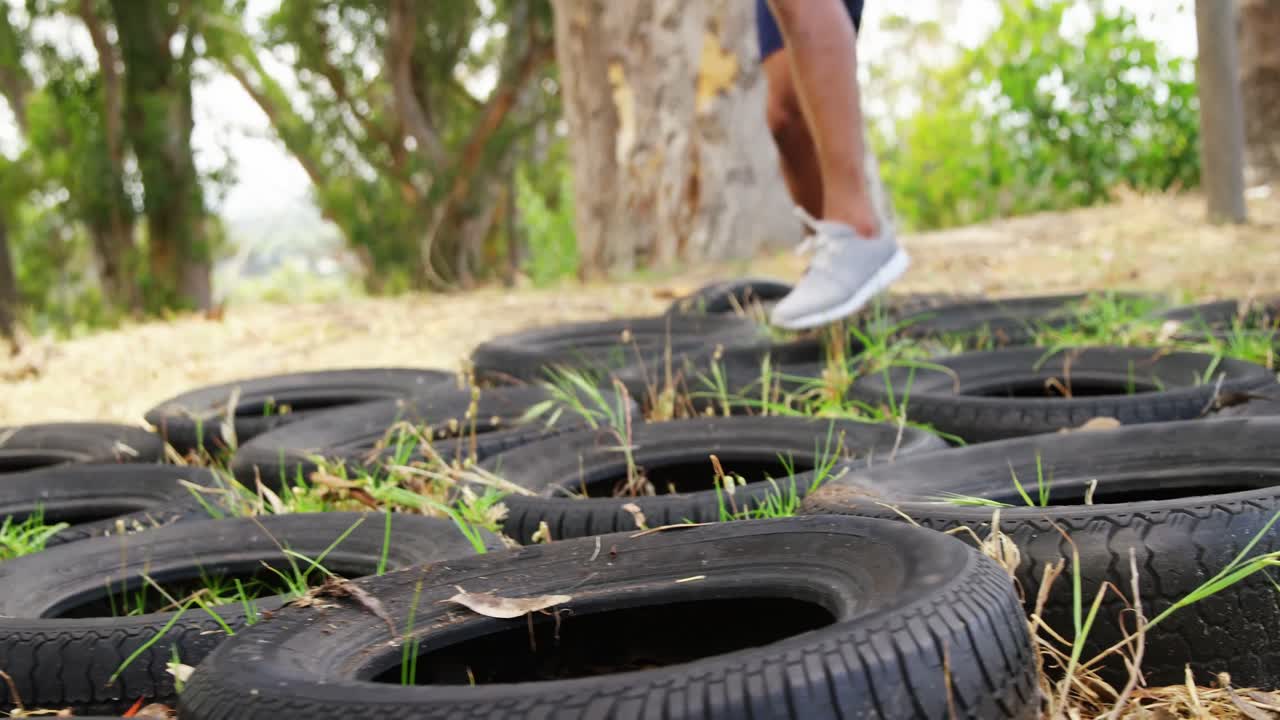 Fit people practicing tire obstacle course training 4k