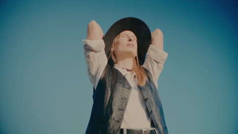 tired woman standing against blue sky