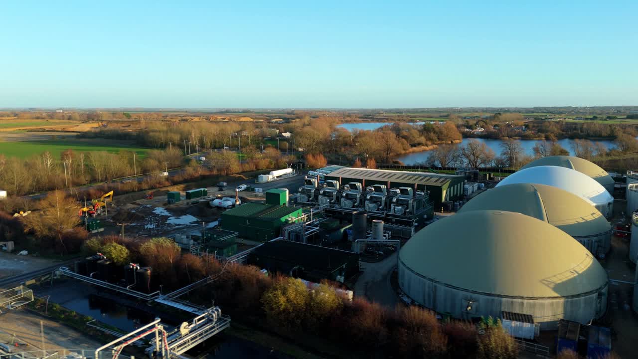 Aerial drone view of an industrial anaerobic digestion facility, highlighting the distinctive storage domes used for biogas capture and methane conversion