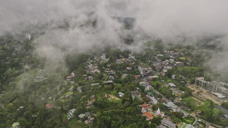 Ella-Sri-Lanka-Aerial-v21-drone-flyover-town-center,-fly-through-fluffy-clouds-capturing-hillside-resort-hotels-on-the-hilly-terrains-and-lush-mountain-landscape---Shot-with-Mavic-3-Cine---April-2023