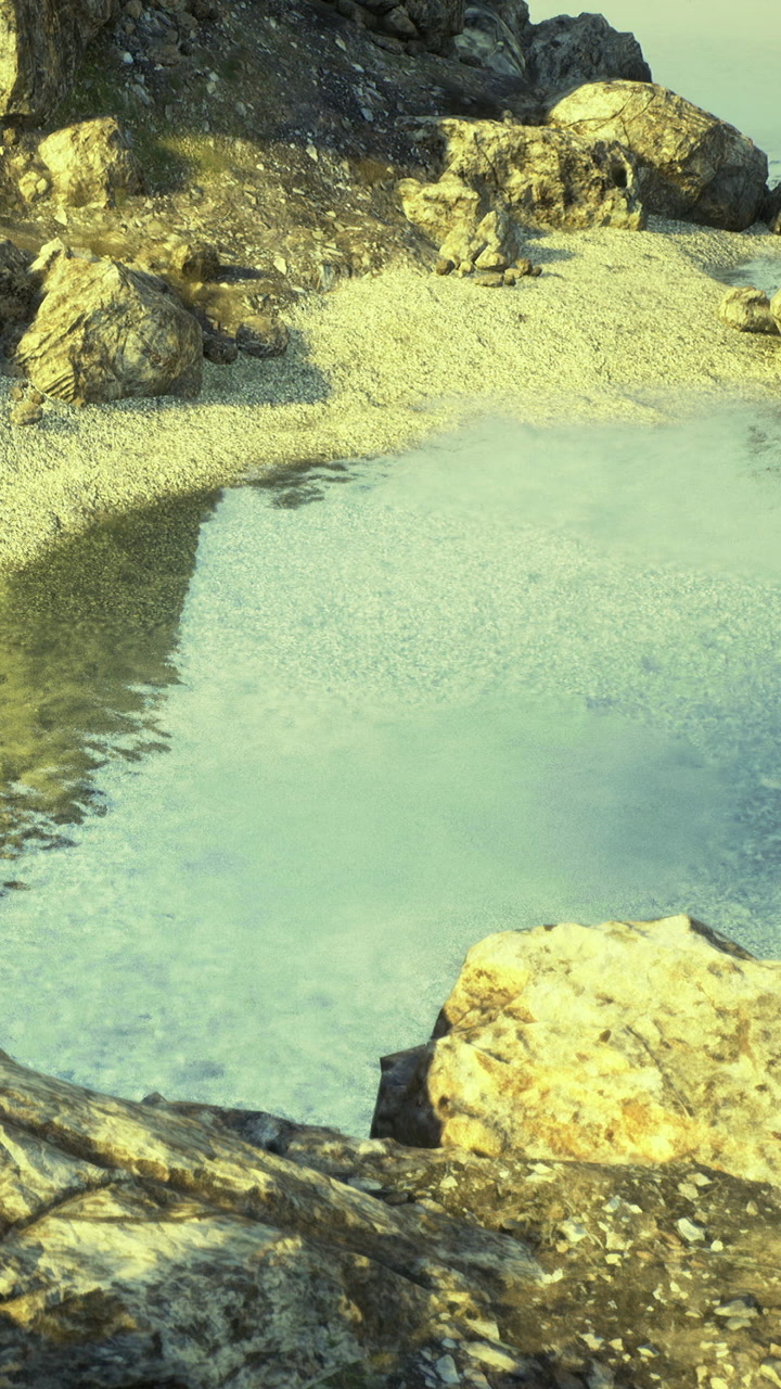 Clear water and rocks near a shoreline with small pebbles and sand