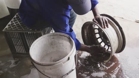 african man cleaning a wheel