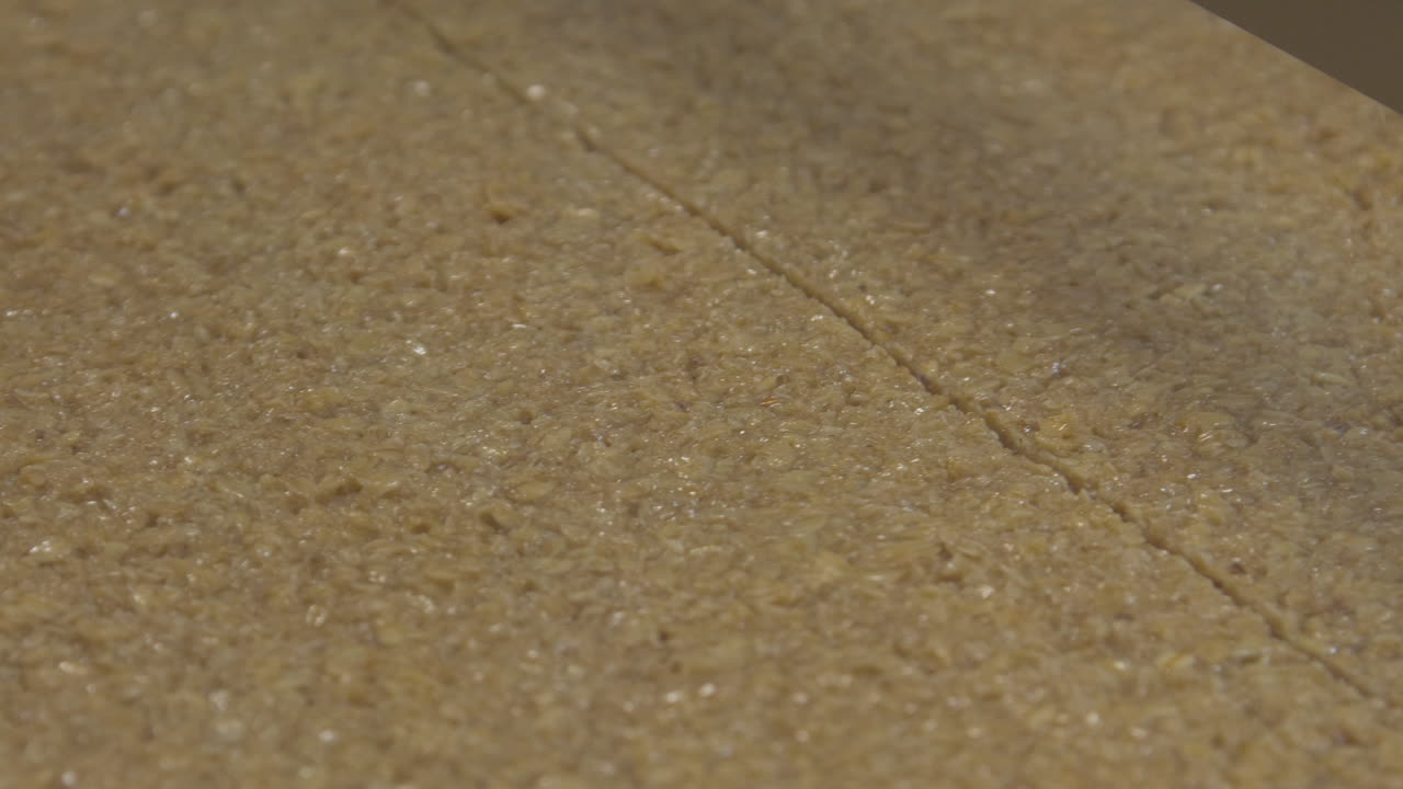 Close up of a precision cutter slicing flapjack into small bars