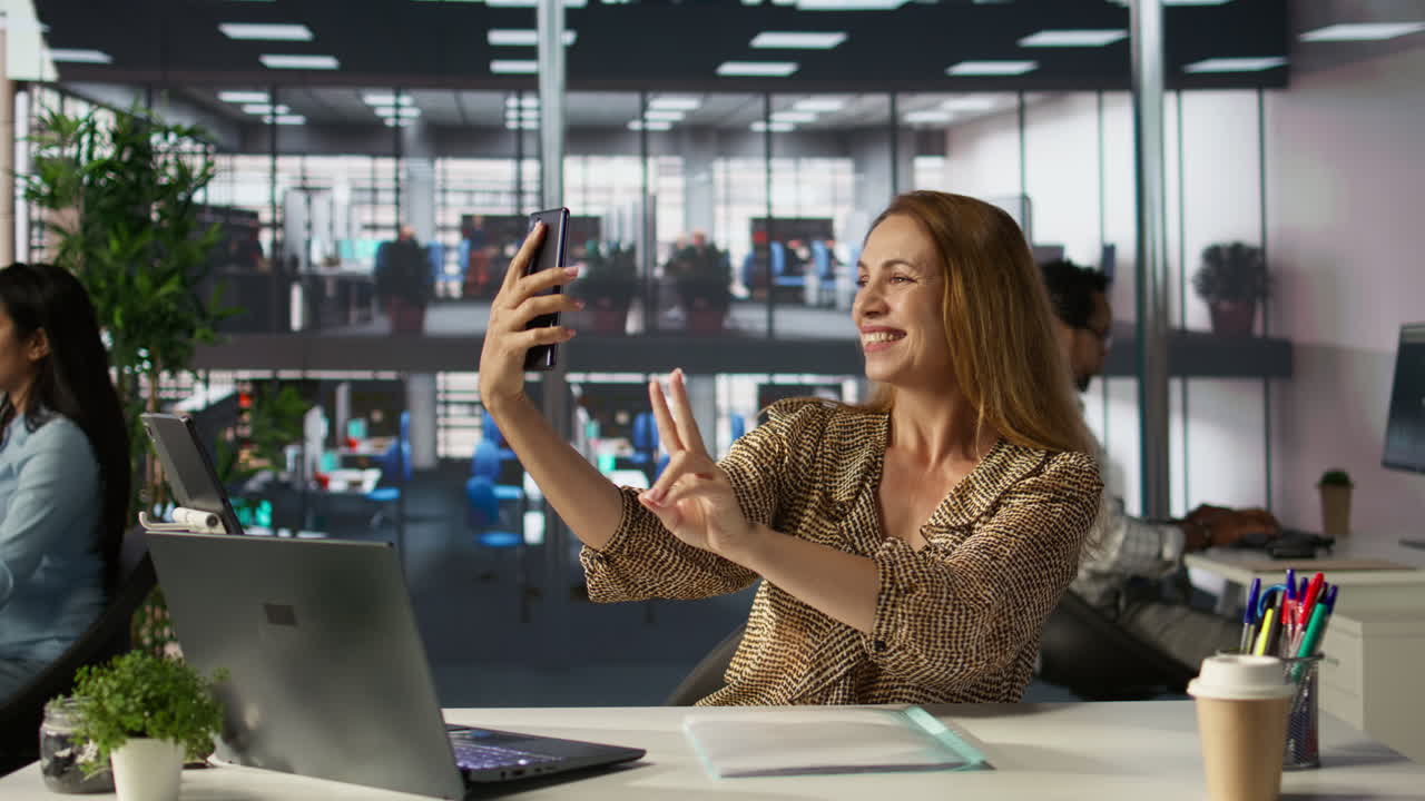 Woman taking selfie in office