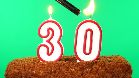 cake with the number 30 lighted candle. chroma key. green screen. isolated