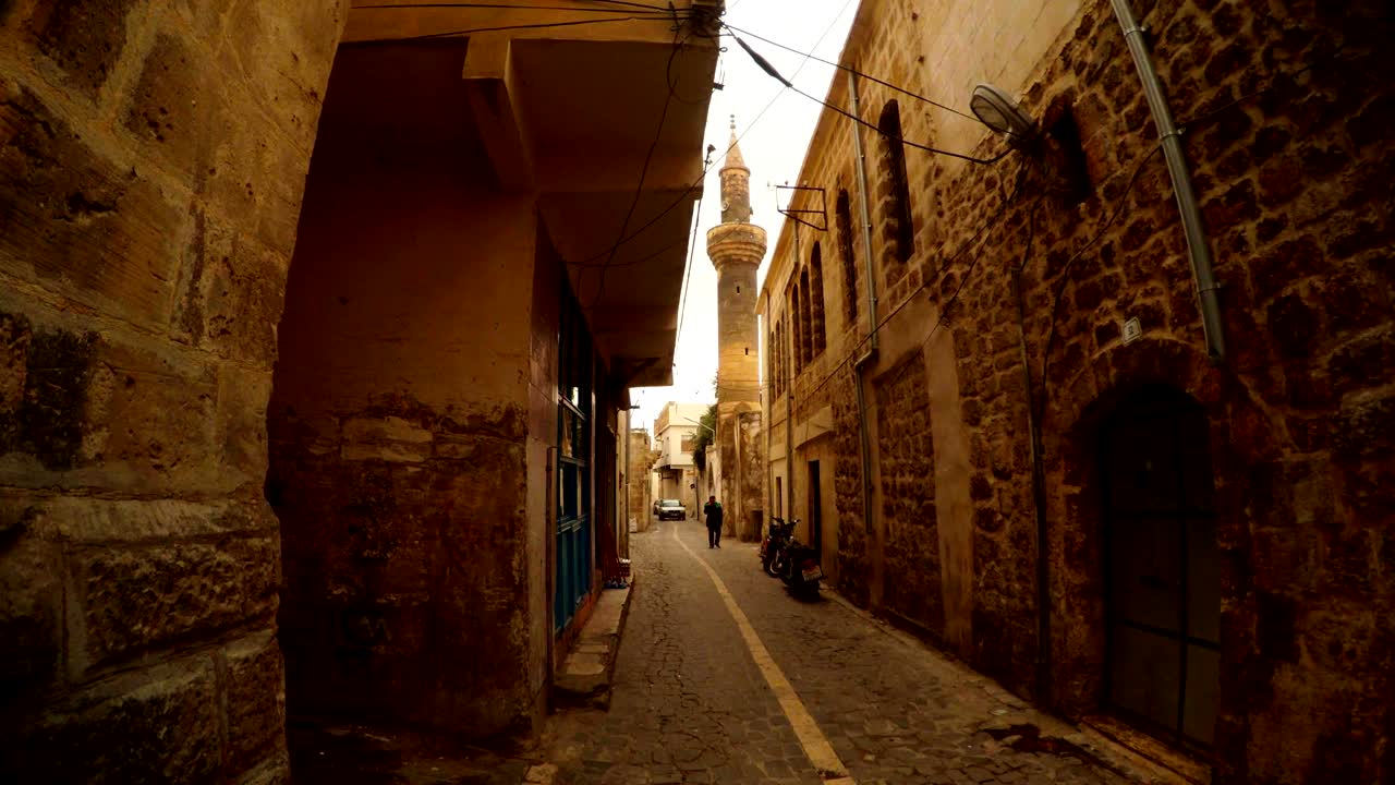 Minaret of Old Mosque Tower Above Narrow Ancient Stone Street Urfa