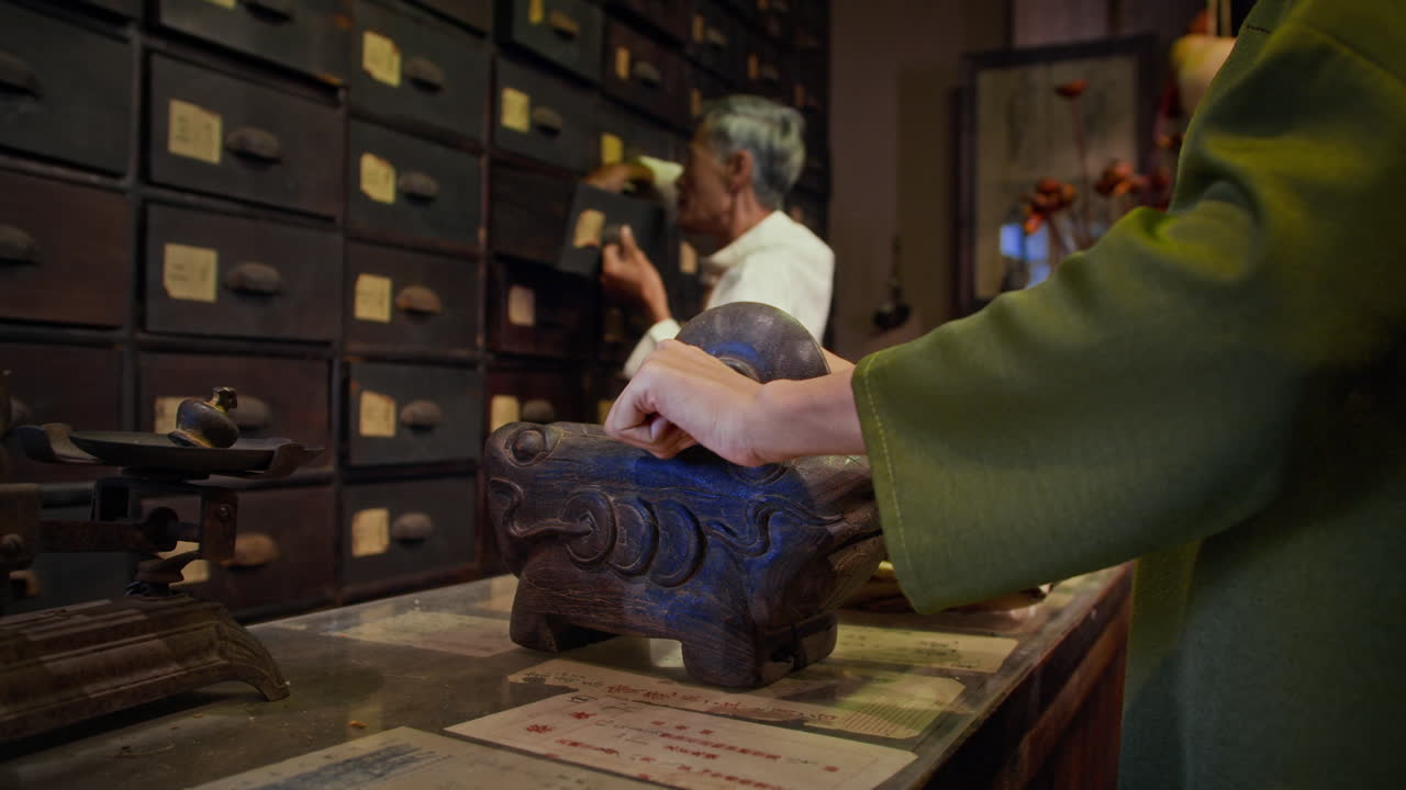 Unrecognizable Female Homeopath Rolling Herbs in Mortar for Grinding