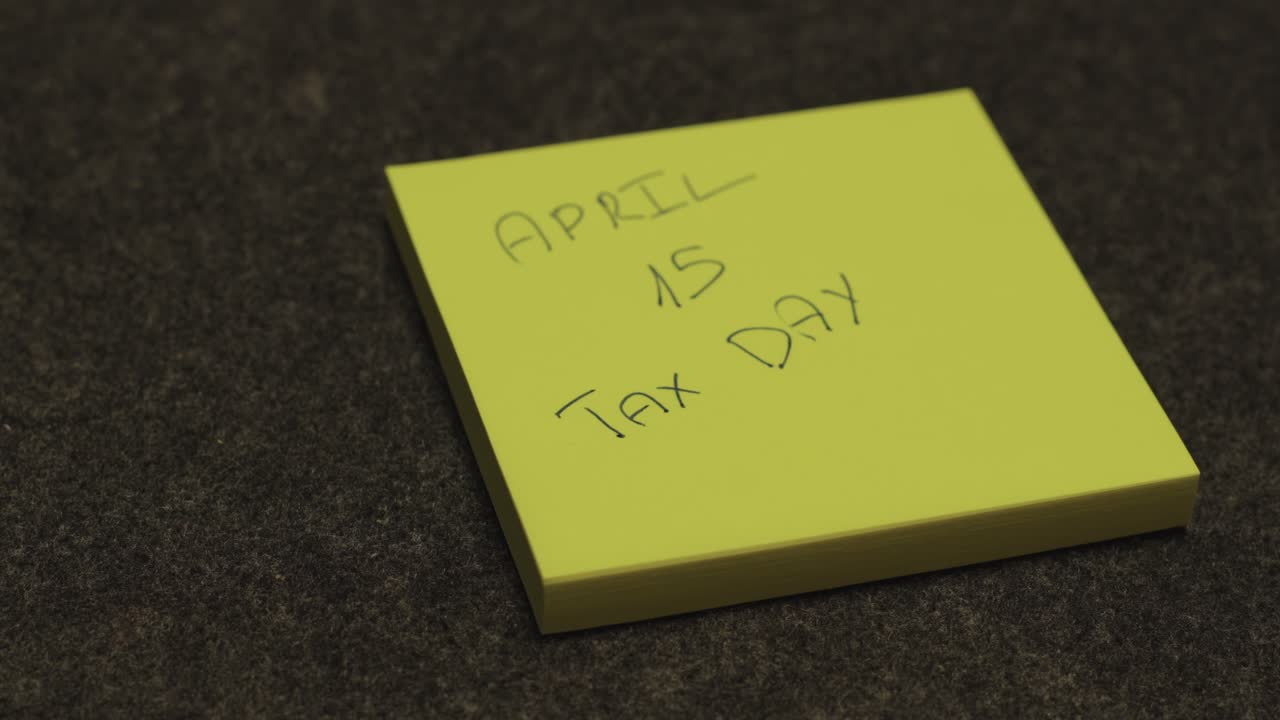 Close Up of a Sticky Note for Tax Day on April 15