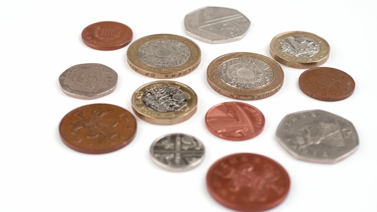 moneda británica libras monedas girando imágenes de cerca contra el fondo blanco