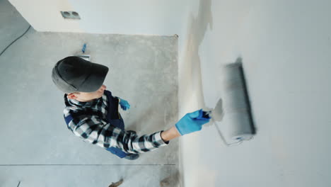 malar paints the wall in the house