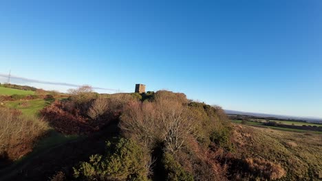 fpv drone flying towards billinge hill beacon autumn lancashire farmland woodland