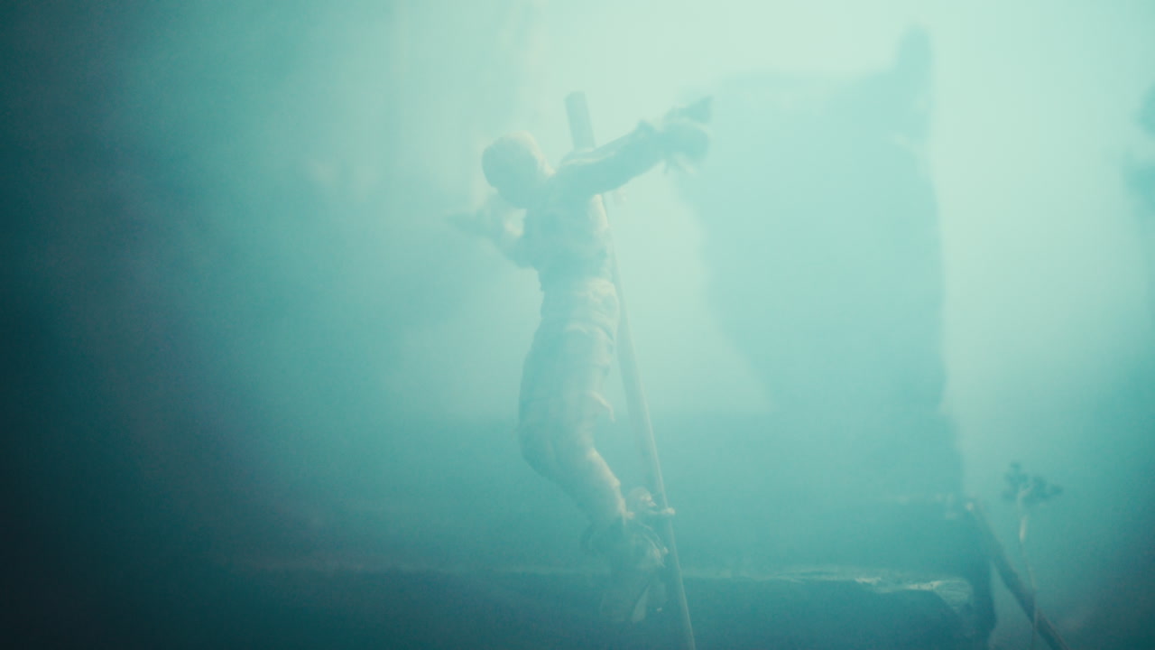 Miniature mummified dolls hanging on the gallows at night