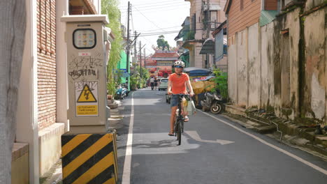 asian woman on bicycle sightseeing in thailand