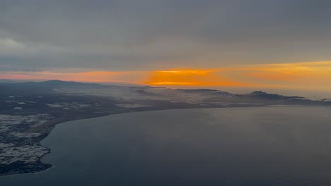 fire sunrise in almeria coast and cabo de gata, spain, shot from a plane cockpit