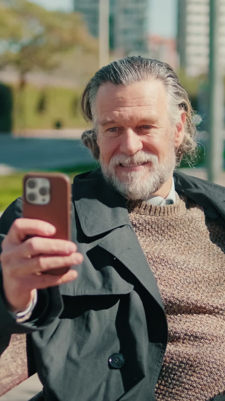 Happy Senior Man Making Video Call in Park