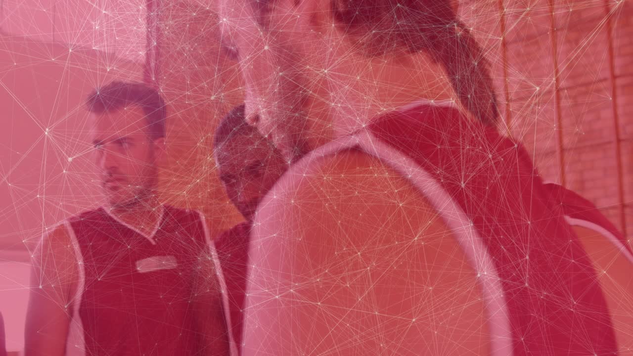 Coach speaking, rotating basketball and tossing upward, players reaching hands preparing for game