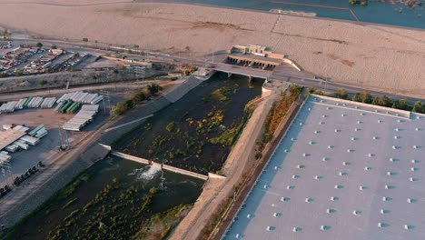 water from santa fe dam flows down the stream in irwindale, california, us